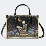 Skeleton Reading A Book Among Flowers - Leather Handbag